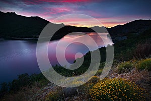 Summer mountains landscape with lake in sunset