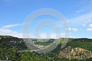 Green hills and cloudy sky.Aerial view of valley with green spring crop fields