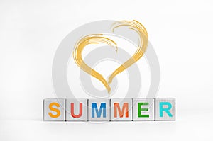 Summer. Multi-colored letters on wooden cubes. A heart