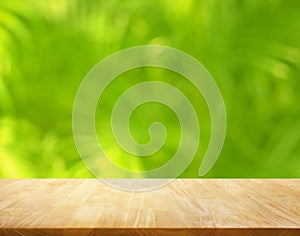 Summer and nature product display with wood table counter on blur coconut leaf background