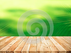 Summer and nature product display with wood table  counter on blur coconut leaf background.fresh green tropical garden.For key