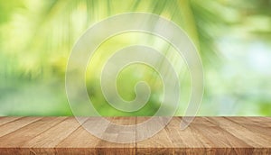 Summer and nature product display with wood table counter on blur coconut leaf background.fresh green tropical garden