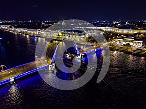 Summer night, Saint Petersburg, Russia. Neva River. A ship passes under drawn bascule moveable Palace bridge. Winter Palace.