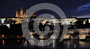 Summer night view of Charles Bridge over the Vltava in the historical part of Prague