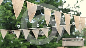 Summer Nights Redefined: Elevate your outdoor gatherings with beige triangle flags and soft-glowing light bulbs. Embrace