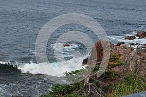 Summer in Nova Scotia: Wave Breaks on Rocky Shore Near Ingonish on Cape Breton Island