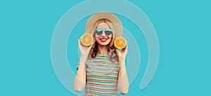 Summer, nutrition, diet and vegetarian concept. Happy healthy smiling young woman with slices of orange fruits wearing straw hat,