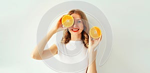 Summer, nutrition, diet and vegetarian concept. Happy healthy smiling young woman with slices of orange fruits on white background