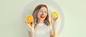 Summer, nutrition, diet and vegetarian concept. Happy healthy smiling young woman with slices of orange fruits on white background
