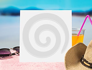 Summer offer background template for promotion and sales. Sunglasses, cocktail and brimmed hat on towel with beautiful paradise.