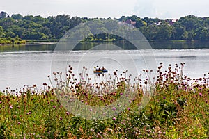 Summer in Omaha, Two boaters in kayaks with Shoreline and sky reflections in the lake at Ed Zorinsky Lake Park Omaha NE