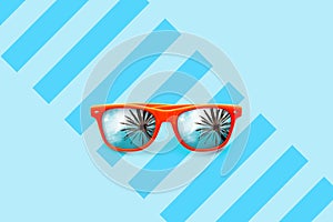 Summer orange sunglasses with palm trees reflections isolated in large blue background with partial stripes