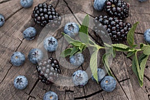 Summer organic berries. healthy food. mixed fresh berries. blackberry, blueberry and mint leaves