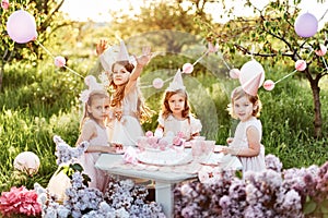 Summer outdoor kids birthday party. Group of happy Children celebrating birthday in park.