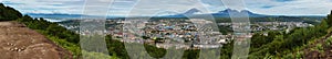 Summer panorama of Petropavlovsk-Kamchatsky on background Avachinskaya group Volcano. View from Mishennaya hills.