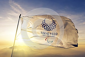 2020 Summer Paralympics Emblem flag textile cloth fabric waving on the top sunrise mist fog