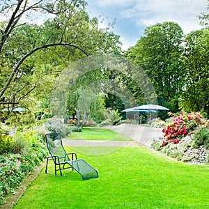 summer park with green lawns and flower beds