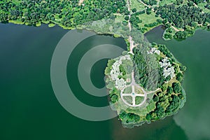 Summer park landscape. island on lake with round walkway. aerial view