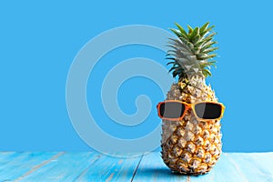 Summer in the party.  Hipster Pineapple Fashion in sunglass bright beautiful color in holiday, Creative art fruit for tropical sty