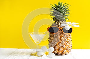 Summer in the party.  Hipster Pineapple Fashion in sunglass and fruit juice bright beautiful color in holiday,