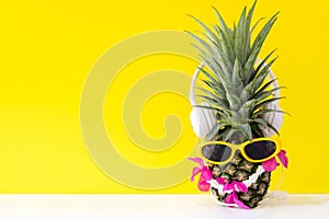 Summer in the party. Hipster Pineapple Fashion in sunglass and listen music bright beautiful color in holiday,