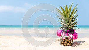 Summer in the party.  Hipster Pineapple Fashion in sunglass and listen music on the sand beach beautiful blue sky background.