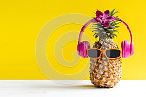 Summer in the party.  Hipster Pineapple Fashion in sunglasses and music bright beautiful color in holiday, Creative art fruit for