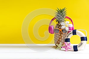 Summer in the party. Hipster Pineapple Fashion in sunglasses and music bright beautiful color in holiday, Creative art fruit for