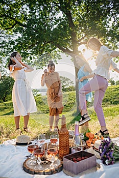 Summer party, Outdoor Gathering with friends. Five young women, Friends at the picnic dancing and having fun on summer