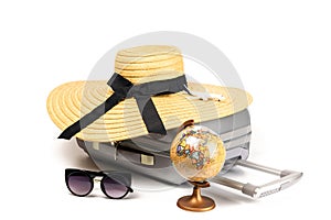 Summer pattern background. Suitcase, sunglasses with toy plane, straw hat and globe in travel composition isolated on
