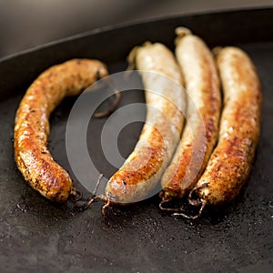 Summer picnic with barbeque sausages on black oven