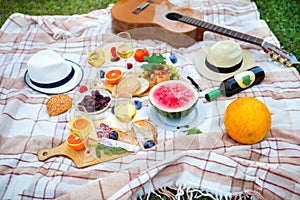 Summer Picnic Basket on the Green Grass. Food and drink concept.