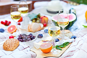 Summer Picnic Basket on the Green Grass. Food and drink concept.