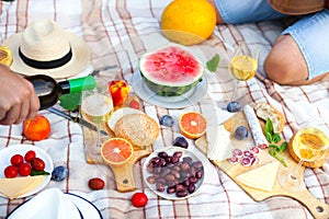 Summer Picnic Basket on the Green Grass. Food and drink concept.