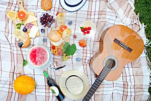 Summer Picnic Basket on the Green Grass. Food and drink concept.