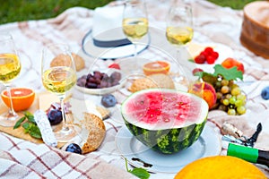 Summer Picnic Basket on the Green Grass. Food and drink concept.