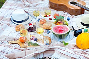 Summer Picnic Basket on the Green Grass. Food and drink concept.