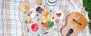 Summer Picnic Basket on the Green Grass. Food and drink concept.