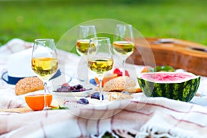 Summer Picnic Basket on the Green Grass. Food and drink concept.