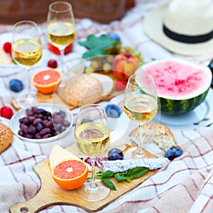 Summer Picnic Basket on the Green Grass. Food and drink concept.