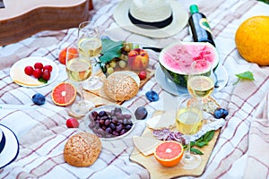 Summer Picnic Basket on the Green Grass. Food and drink concept.