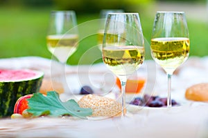 Summer Picnic Basket on the Green Grass. Food and drink concept.