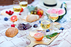 Summer Picnic Basket on the Green Grass. Food and drink concept.