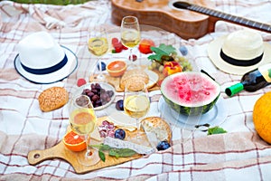 Summer Picnic Basket on the Green Grass. Food and drink concept.