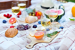 Summer Picnic Basket on the Green Grass. Food and drink concept.