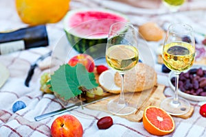 Summer Picnic Basket on the Green Grass. Food and drink concept.