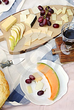 Summer picnic with cheese, wine, fruits and bread.