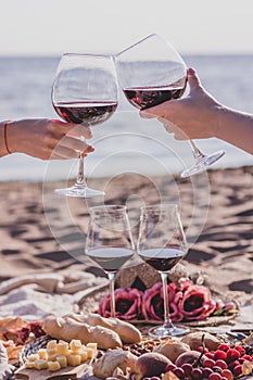 Summer picnic party on the beach with red wine.