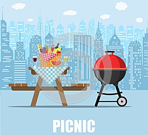 Summer picnic table on city background.