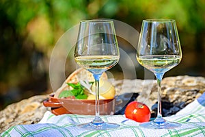 Summer picnic or wine tasting of white wine on vineyards in Lazio, Italy